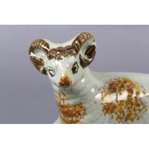 278 - AN 18TH CENTURY PRATTWARE FIGURE OF A RAM, the pearlware body sponged in ochre, manganese brown and ... 