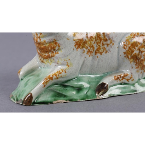 278 - AN 18TH CENTURY PRATTWARE FIGURE OF A RAM, the pearlware body sponged in ochre, manganese brown and ... 