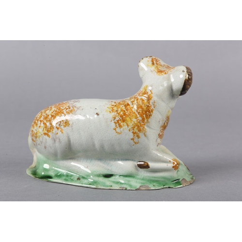 278 - AN 18TH CENTURY PRATTWARE FIGURE OF A RAM, the pearlware body sponged in ochre, manganese brown and ... 