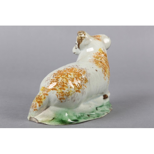 278 - AN 18TH CENTURY PRATTWARE FIGURE OF A RAM, the pearlware body sponged in ochre, manganese brown and ... 