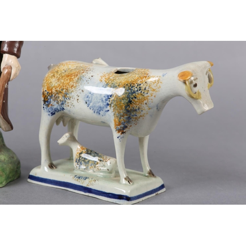 279 - A 19TH CENTURY PRATTWARE CREAMER, formed as a cow and calf, the pearlware body sponged in blue and o... 