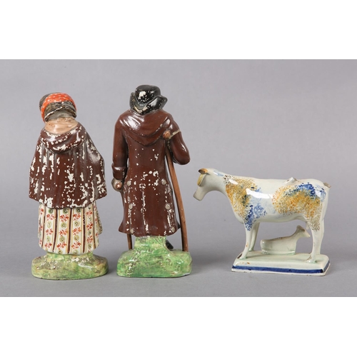 279 - A 19TH CENTURY PRATTWARE CREAMER, formed as a cow and calf, the pearlware body sponged in blue and o... 