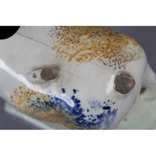 279 - A 19TH CENTURY PRATTWARE CREAMER, formed as a cow and calf, the pearlware body sponged in blue and o... 