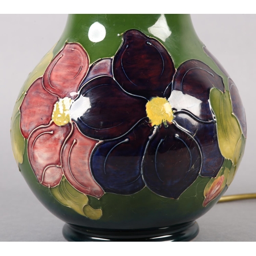 273 - A MOORCROFT LAMP of baluster form, painted and tube lined with Clematis pattern in purples and pinks... 