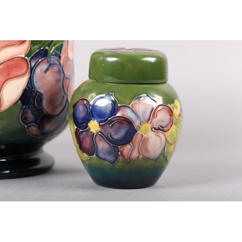 274 - A MOORCROFT JARDINIERE painted and tube lined in the Anemone pattern in pinks and purples on a green... 