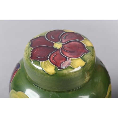 274 - A MOORCROFT JARDINIERE painted and tube lined in the Anemone pattern in pinks and purples on a green... 