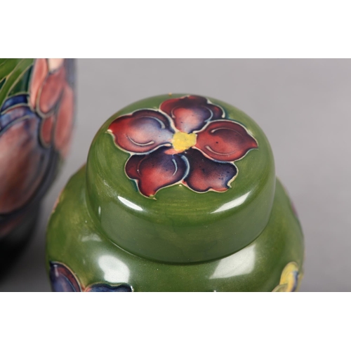 274 - A MOORCROFT JARDINIERE painted and tube lined in the Anemone pattern in pinks and purples on a green... 