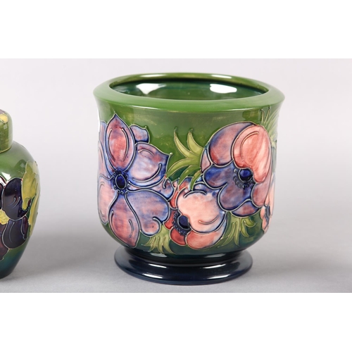 274 - A MOORCROFT JARDINIERE painted and tube lined in the Anemone pattern in pinks and purples on a green... 