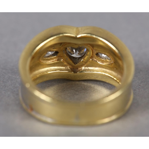 371 - A THREE STONE DIAMOND RING collet set in yellow metal to the centre with a heart shaped faceted ston... 