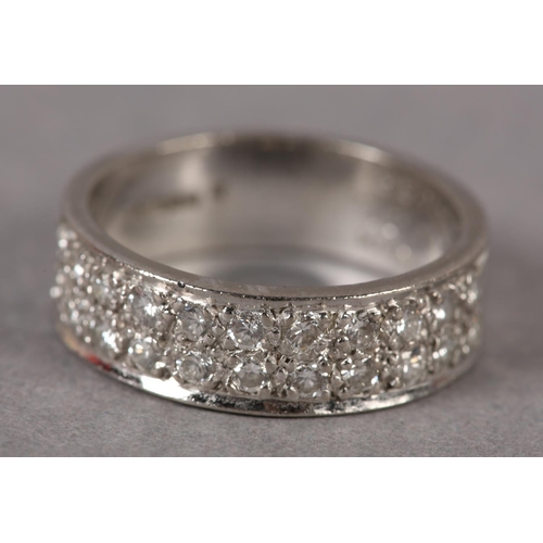 349 - A DIAMOND SET RING IN 18CT WHITE GOLD, the brilliant cut stones grain set to half the band in parall... 