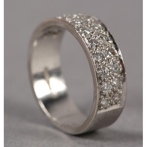 349 - A DIAMOND SET RING IN 18CT WHITE GOLD, the brilliant cut stones grain set to half the band in parall... 