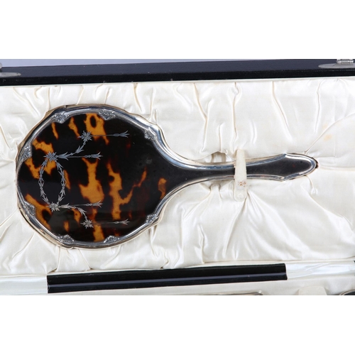 331 - A GEORGE V TORTOISESHELL AND SILVER DRESSING TABLE SET, Birmingham 1925 for Williams Ltd, the hand m... 