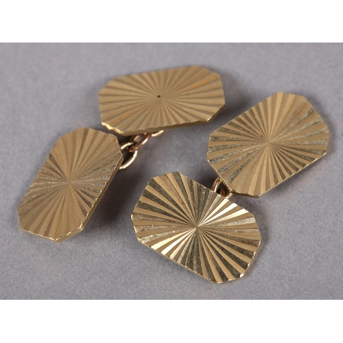 387 - A PAIR OF CUFFLINKS in 9ct gold, c1983, each octagonal face bright cut in sunburst pattern joined by... 