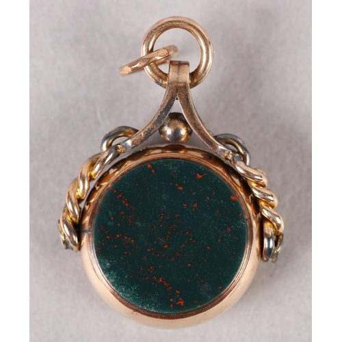 388 - A VICTORIAN BLOODSTONE AND CORNELIAN SWIVEL FOB in 9ct rose gold, Chester 1889 for George K Leeson, ... 