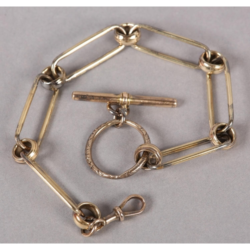 389 - AN EARLY VICTORIAN SINGLE GUARD WATCH CHAIN in 9ct gold, trace and fetter links with later 9ct gold ... 