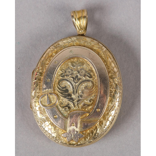 360 - A VICTORIAN OVAL LOCKET in 9ct gold, back and front, foliate engraved with belted surround to the fr... 