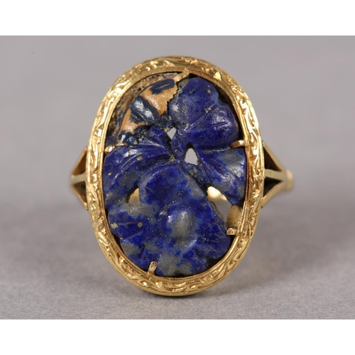 368 - A SODALITE DRESS RING c1950 in 18ct gold, the foliate pierced and carved oval cabochon claw set with... 