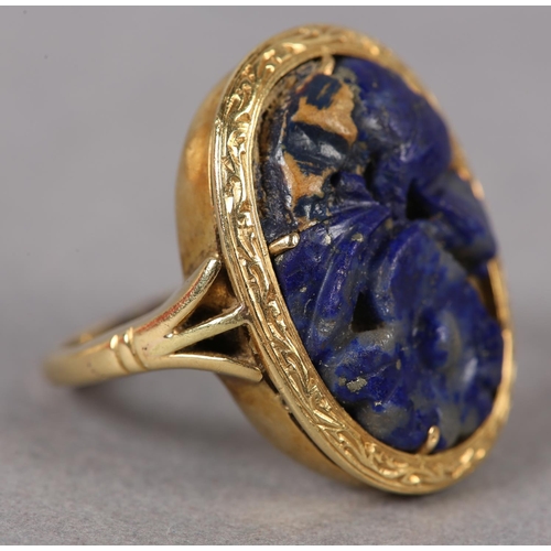 368 - A SODALITE DRESS RING c1950 in 18ct gold, the foliate pierced and carved oval cabochon claw set with... 