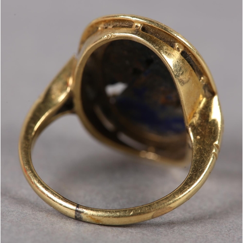 368 - A SODALITE DRESS RING c1950 in 18ct gold, the foliate pierced and carved oval cabochon claw set with... 