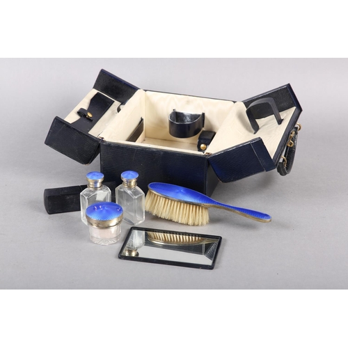 322 - A GEORGE V COMPOSITE TRAVELLING DRESSING TABLE, part set, in silver and blue guilloche enamel, the p... 