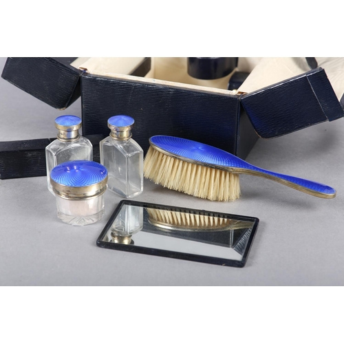 322 - A GEORGE V COMPOSITE TRAVELLING DRESSING TABLE, part set, in silver and blue guilloche enamel, the p... 