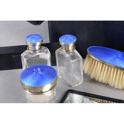 322 - A GEORGE V COMPOSITE TRAVELLING DRESSING TABLE, part set, in silver and blue guilloche enamel, the p... 