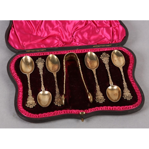 329 - A SET OF SIX VICTORIAN SILVER GILT TEASPOONS AND SUGAR TONGS, London 1895 for Wakely & Wheeler, each... 