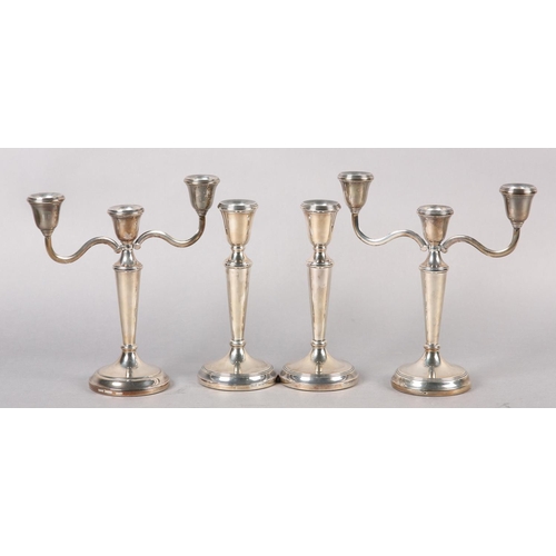 333 - A SUITE OF THREE ELIZABETH II SILVER CANDLE STICKS, including a three light candelabra and a pair of... 