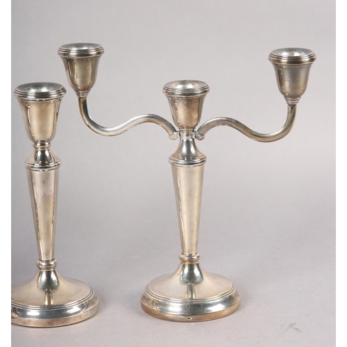 333 - A SUITE OF THREE ELIZABETH II SILVER CANDLE STICKS, including a three light candelabra and a pair of... 