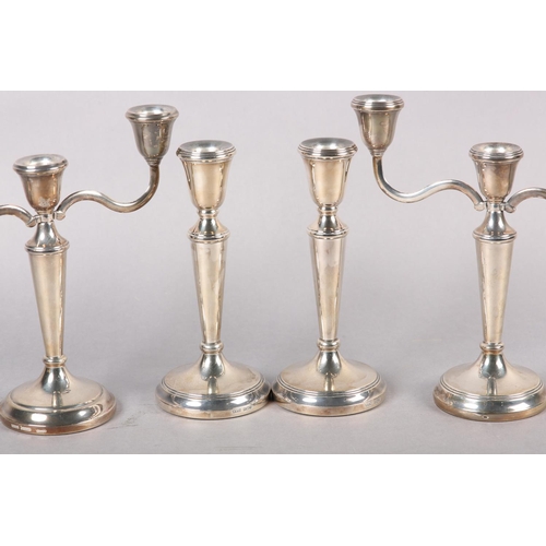 333 - A SUITE OF THREE ELIZABETH II SILVER CANDLE STICKS, including a three light candelabra and a pair of... 