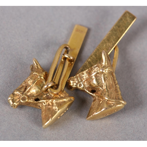 385 - A PAIR OF HORSE'S HEAD CUFFLINKS in 9ct gold, c1978, in full relief wearing bridal and bit joined to... 