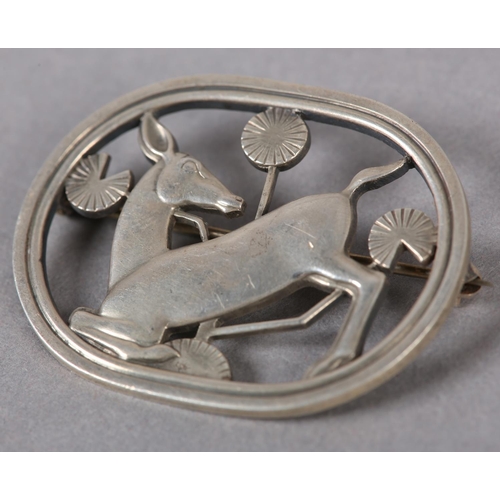 400 - A GEORG JENSEN 256 SILVER DEER BROOCH designed by Arno Malinowski, the kneeling doe and flowers pier... 