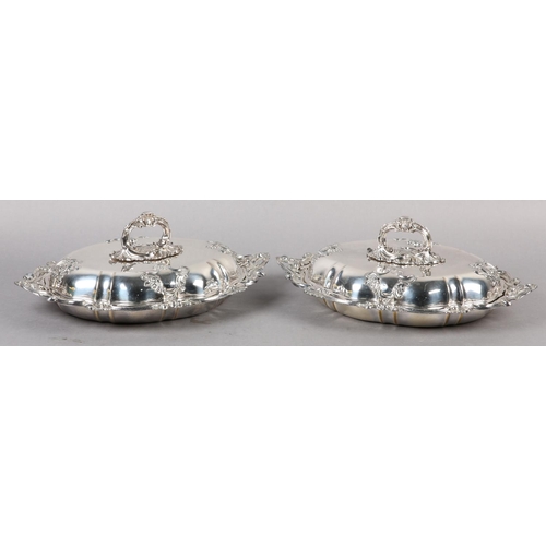 303 - A PAIR OF VICTORIAN TUREENS IN IN SILVER PLATE each of oval outline with foliate swagged bayonet han... 