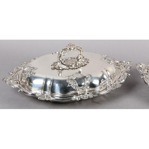 303 - A PAIR OF VICTORIAN TUREENS IN IN SILVER PLATE each of oval outline with foliate swagged bayonet han... 