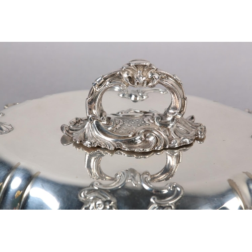 303 - A PAIR OF VICTORIAN TUREENS IN IN SILVER PLATE each of oval outline with foliate swagged bayonet han... 