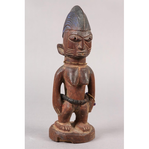 155 - NIGERIA YORUBA, EARLY 20TH CENTURY, a female Ibeji figure with coiffured hair, scarification to the ... 