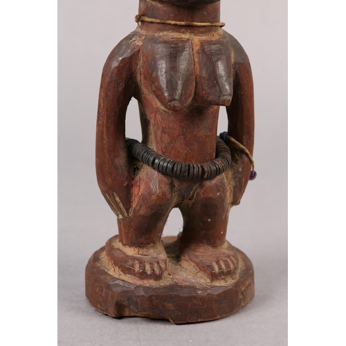 155 - NIGERIA YORUBA, EARLY 20TH CENTURY, a female Ibeji figure with coiffured hair, scarification to the ... 