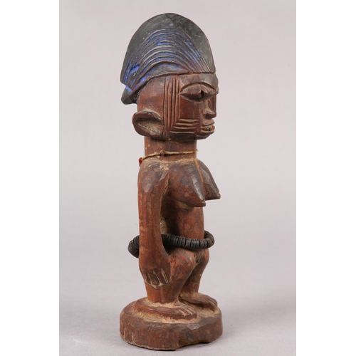 155 - NIGERIA YORUBA, EARLY 20TH CENTURY, a female Ibeji figure with coiffured hair, scarification to the ... 