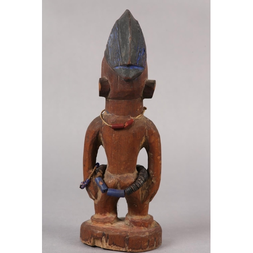 155 - NIGERIA YORUBA, EARLY 20TH CENTURY, a female Ibeji figure with coiffured hair, scarification to the ... 