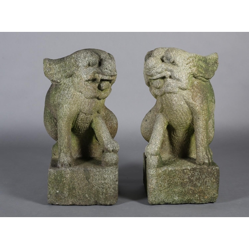 292 - A PAIR OF LATE 19TH CENTURY CARVED STONE GARDEN STATUES modelled as Dogs of Fo both holding a ball, ... 