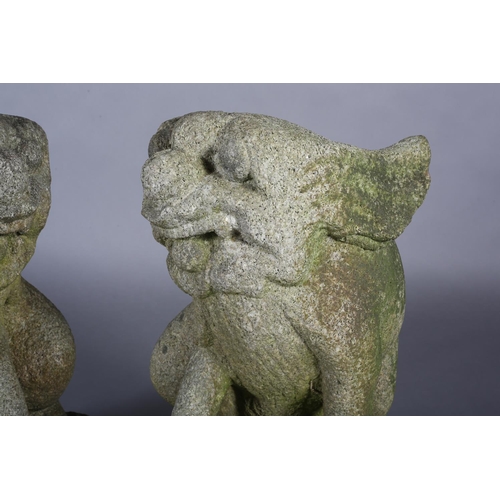 292 - A PAIR OF LATE 19TH CENTURY CARVED STONE GARDEN STATUES modelled as Dogs of Fo both holding a ball, ... 