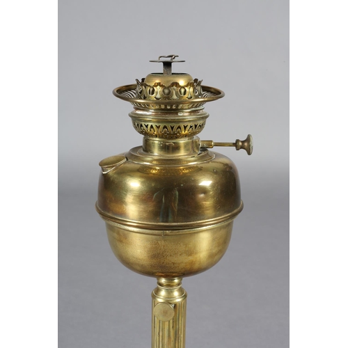 172 - A VICTORIAN BRASS OIL LAMP, on a reeded column, the domed base embossed with grapevine on a black gl... 