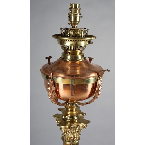 173 - A LATE 19TH/EARLY 20TH CENTURY BRASS STANDARD OIL LAMP, converted to electricity, having a copper re... 