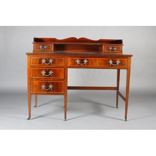 483 - AN EDWARD VII MAHOGANY AND SATINWOOD BANDED DESK, having a raised back with ogee arch, two small dra... 