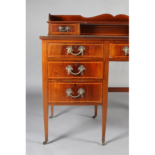 483 - AN EDWARD VII MAHOGANY AND SATINWOOD BANDED DESK, having a raised back with ogee arch, two small dra... 