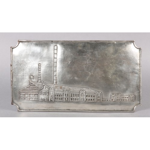 305 - A MID 20TH CENTURY SILVER PLAQUE, chased with the image of an Indian factory within a landscape of r... 