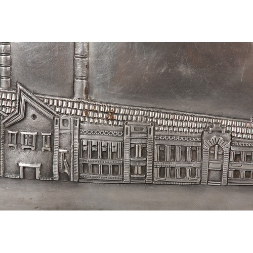 305 - A MID 20TH CENTURY SILVER PLAQUE, chased with the image of an Indian factory within a landscape of r... 