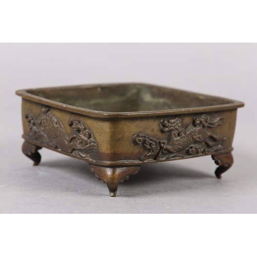 282 - A 19TH CENTURY CHINESE BRONZE CENSER, of square shallow form, the sides cast with alternating flying... 