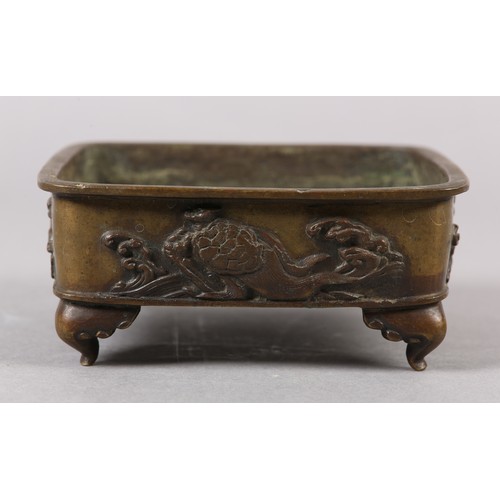 282 - A 19TH CENTURY CHINESE BRONZE CENSER, of square shallow form, the sides cast with alternating flying... 