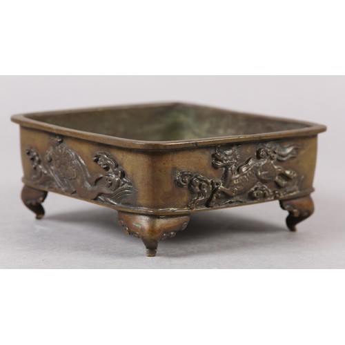 282 - A 19TH CENTURY CHINESE BRONZE CENSER, of square shallow form, the sides cast with alternating flying... 